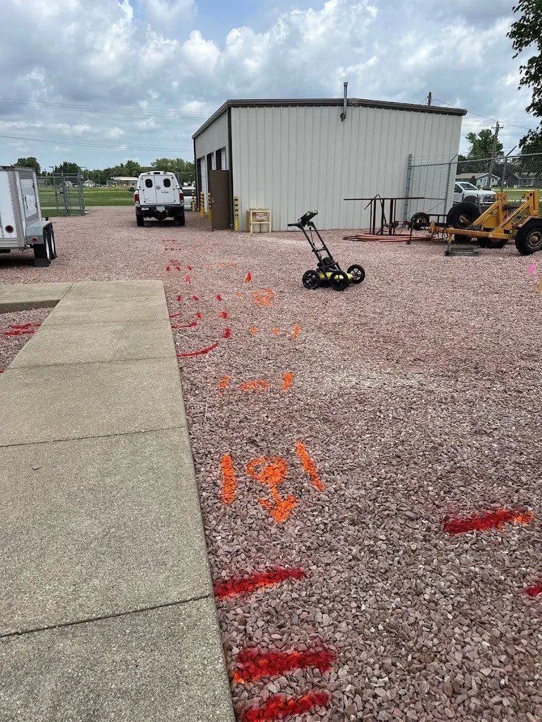 Ground-penetrating radar equipment investigating marked utilities at a project site