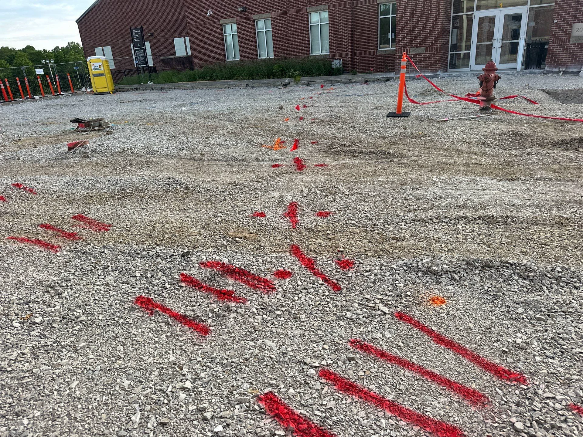 Private utility markings across a commercial excavation area